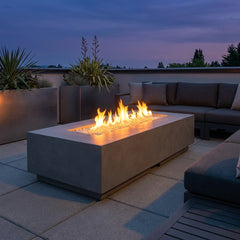 AFD Contempo LP Select Long fire table in Smoke burning on a modern terrace at dusk
