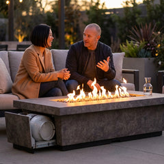 Couple beside the AFD Contempo LP Select Long fire table at dusk