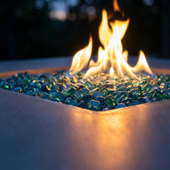 Close-up of flames over blue glass on the AFD Cosmopolitan Square dining fire table