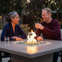 Couple at the dining-height AFD Cosmopolitan Square fire table at dusk