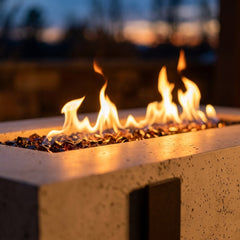 Close-up of the linear flame and iron strap detail of the AFD Iron Saddle Long fire table