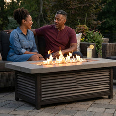 Couple beside the AFD Louvre Long fire pit at dusk