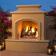 American Fyre Designs Mariposa outdoor gas fireplace burning on a Spanish terrace at dusk