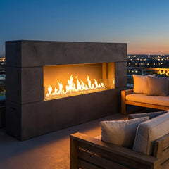 American Fyre Designs Milan Low linear outdoor fireplace in Black Lava on a rooftop at dusk