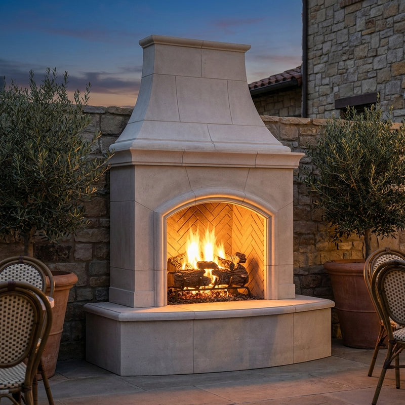 American Fyre Designs Phoenix outdoor gas fireplace burning in a courtyard at dusk