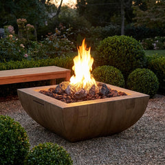 AFD Reclaimed Wood Bordeaux Square fire bowl with lava rock burning in a garden at dusk