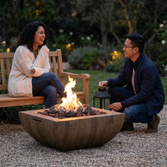 Two friends beside the AFD Bordeaux Square fire bowl at dusk