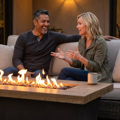 Couple chatting beside the AFD Contempo LP Select Long fire table at dusk