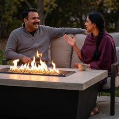 Couple around the AFD Contempo Rectangle fire table at dusk