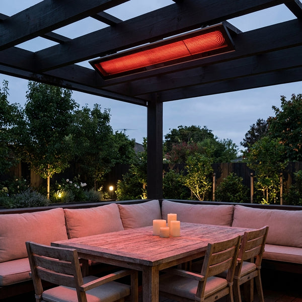 Bromic Platinum Smart-Heat Electric 4500W black panel glowing over a pergola dining nook at dusk