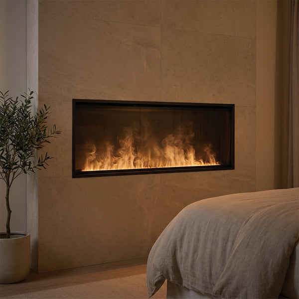 Dimplex 66 inch Opti-myst linear electric fireplace with water-vapor flame recessed in a limestone wall at evening