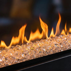 Flame detail: Dimplex Ignite XL 100 built-in linear electric fireplace spanning a loft brick wall at evening