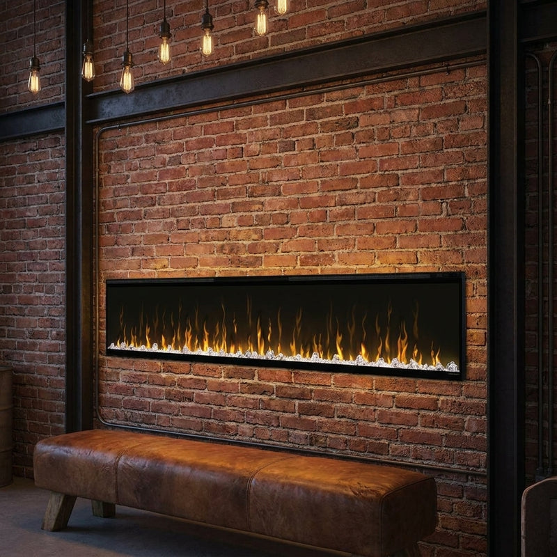 Dimplex Ignite XL 100 built-in linear electric fireplace spanning a loft brick wall at evening