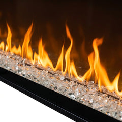 Flame detail: Dimplex Ignite XL 74 built-in linear electric fireplace in a coastal paneled wall at evening
