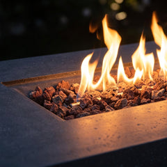 Close-up of flames over lava rock in the recessed tray of the Elementi Andes fire table