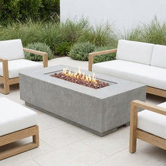 Light gray Elementi Andes fire pit table lit on a bright patio in neutral daylight