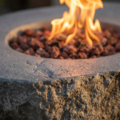 Close-up of flames over lava rock in the Elementi Boulder's rocky rim