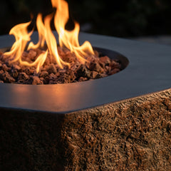 Close-up of flames over lava rock where the Columbia's smooth top meets its rough rock side