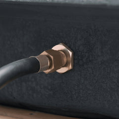 Brass gas hose quick-connect fitting on the side of the Elementi Hampton fire pit table