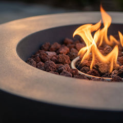 Close-up of flames over lava rock in the Elementi Lunar Bowl's recessed burner