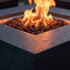 Close-up of flames over lava rock in the Elementi Manhattan's square stainless steel burner