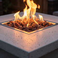 Close-up of flames over lava rock in the Elementi Montreal bar fire pit table