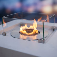 Close-up of the round stainless ethanol burner and square glass surround of the Elementi Perth