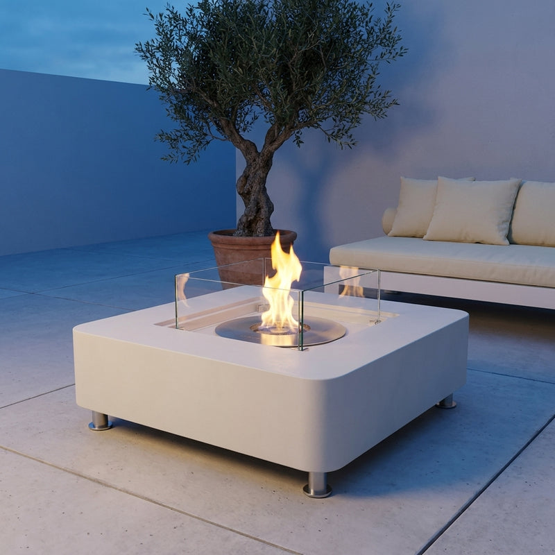 Cream white Elementi Perth square ethanol fire table with round burner and glass surround at dusk