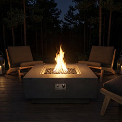 Elementi Plus Bergen dark charcoal square fire table with a tall round flame on a timber deck at night