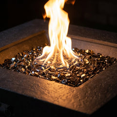 Close-up of the tall round flame over smoky bronze fire glass in the Elementi Plus Bergen