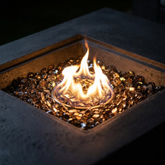 Close-up of the round flame in the square bronze fire glass recess of the Elementi Plus Cannes