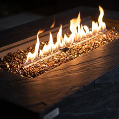 Close-up of flames over bronze fire glass in the slate black sandstone Elementi Plus Cape Town