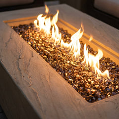 Close-up of flames over bronze fire glass in the sandy sandstone Elementi Plus Colorado