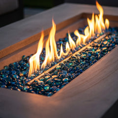 Close-up of flames over Caribbean blue fire glass in the space gray sandstone Elementi Plus Meteora