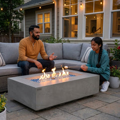 Father and daughter toasting marshmallows at the 15-inch-tall Elementi Plus Meteora fire table at dusk
