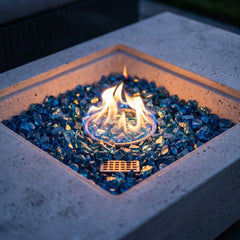 Close-up of the round flame in the square Caribbean blue fire glass recess of the Elementi Plus Monte Carlo