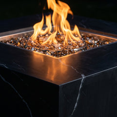 Flames over bronze fire glass in the black marble-look Elementi Plus Sofia, close-up