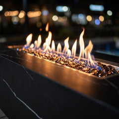 Close-up of flames over bronze fire glass in the veined porcelain slot of the Varna
