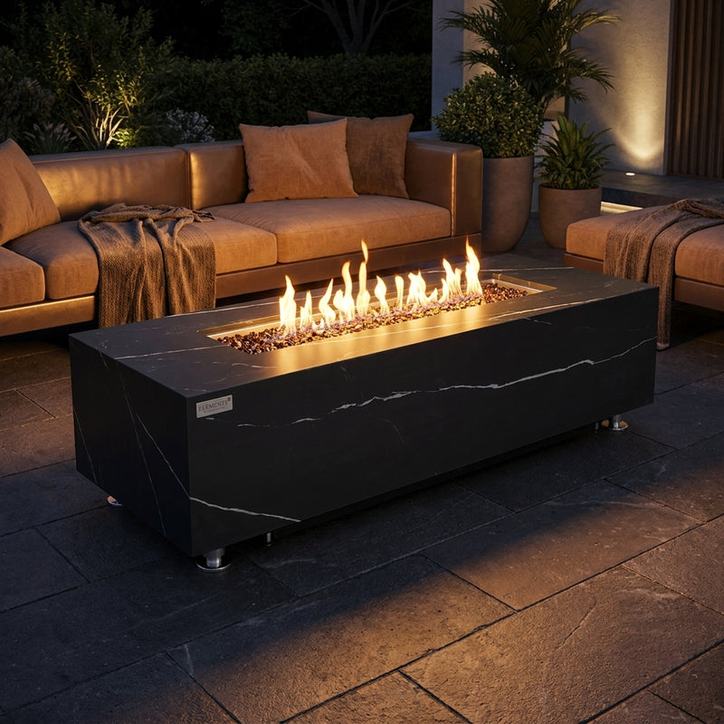Elementi Plus Varna black marble-look porcelain fire table with flames over bronze fire glass at night