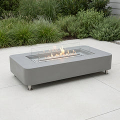 Space gray Elementi Sydney ethanol fire table on a bright patio in neutral daylight