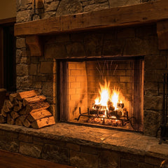 Majestic Biltmore 50 wood burning fireplace roaring in a fieldstone chimney at night