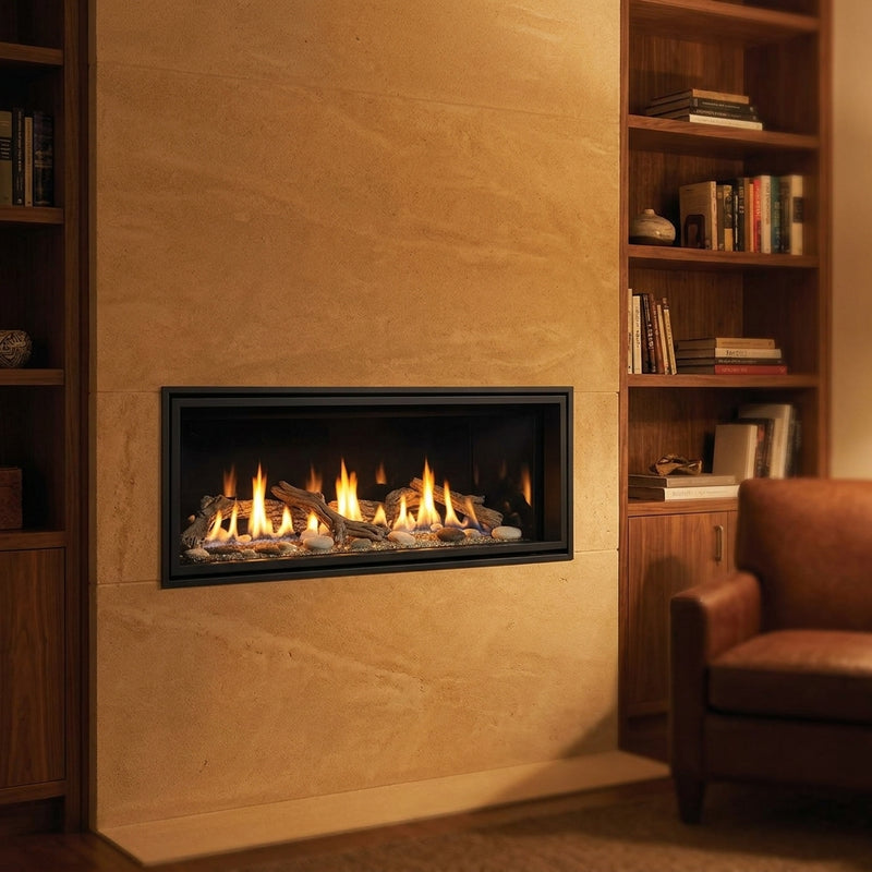 Majestic Echelon II 36 linear direct vent gas fireplace in a limestone study wall, burning at evening