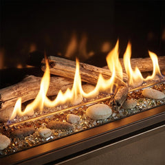 Flame detail: Majestic Echelon II 36 linear direct vent gas fireplace in a limestone study wall, burning at evening