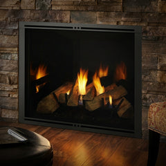 Majestic Marquis II 36 gas fireplace burning in a stacked stone wall at night