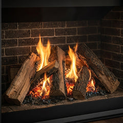 Flame detail: Majestic Meridian 42 direct vent gas fireplace with log set installed in a stone surround, burning at evening