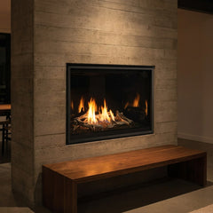 Majestic Meridian 42 Modern gas fireplace with reflective black glass interior in a concrete wall, burning