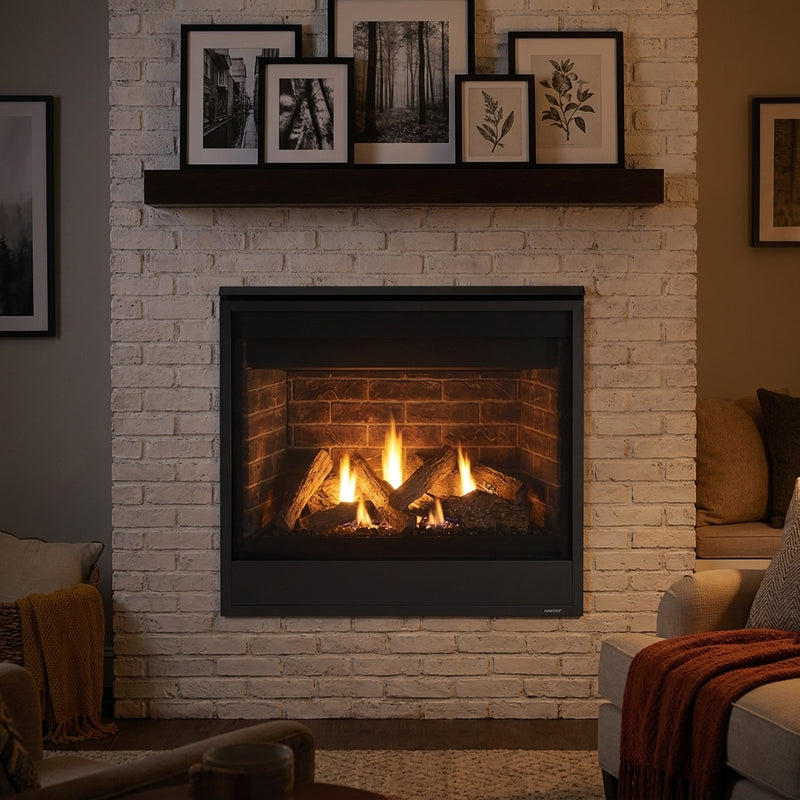 Majestic Quartz 36 direct vent gas fireplace in a whitewashed brick wall, burning at evening
