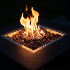Close-up of flames over lava rock in the stainless tray of the Modeno Aurora