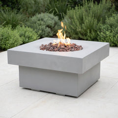 Light gray Modeno Branford fire pit table lit on a bright patio in neutral daylight