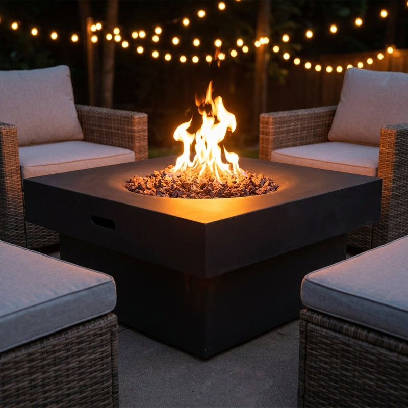 Black Modeno Branford two-tier square fire pit table with flames over lava rock on an evening patio